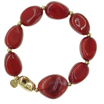 Bracelet Vesta avec pierres rouges marbrées et détails dorés.